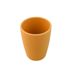 Close-up detail shot of the orange silicone baby training cup showing the smooth rim and matte finish.