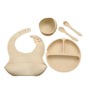 Silicone baby feeding set with suction plate, bib, bowl, spoon, and fork for toddlers.