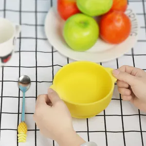 Baby silicone feeding bowl with double handles and cute pineapple spoon for toddler daily use.