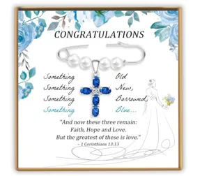 Bridal cross pendant brooch set with simulated pearls and blue crystals on wedding card.