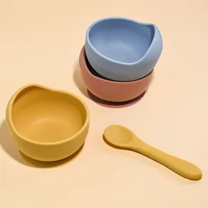 Silicone baby suction bowl and spoon set, detail view of cute colorful snail tableware for kids.