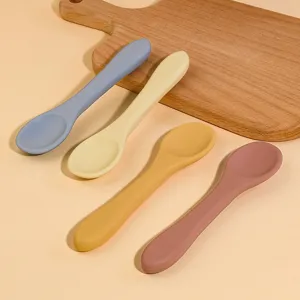 Silicone baby spoon detailed view, colorful long-handled infant feeding tableware.