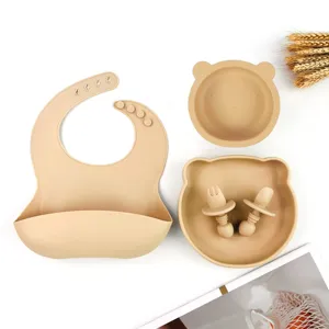 Silicone baby feeding set with bear ear bowl, suction plate, and bib for toddlers.