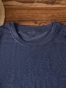 Close-up detail showing the dark blue marled fabric and crewneck of this basic t-shirt.