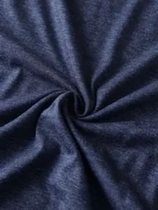 Close-up of solid color dark blue cotton t-shirt fabric showing soft and breathable texture detail.