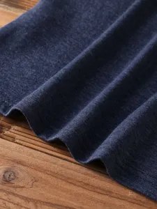 Close-up view of solid color short sleeve t-shirt fabric, showing soft texture and fine stitches.