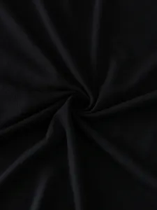Black solid color cotton t-shirt fabric detail close up showing soft texture and fine quality.