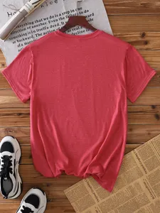 Detailed view of a plain solid red short sleeve t-shirt flatlay on wooden background.