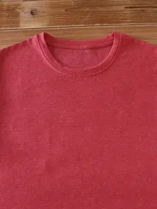 Red crew neck t-shirt detail showing soft fabric texture and neat collar stitching.