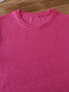Close-up detail of solid color crew neck short sleeve t-shirt fabric and collar workmanship.