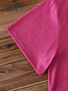 Close-up detail of the pink short sleeve cotton t-shirt sleeve showing fine stitching and fabric.