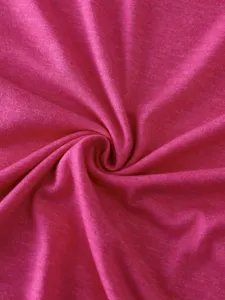 Pink cotton fabric detail shot, soft textile texture swatch for apparel design and clothing.