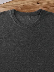 Close-up detail of dark grey crewneck short sleeve t-shirt fabric texture and neckline.