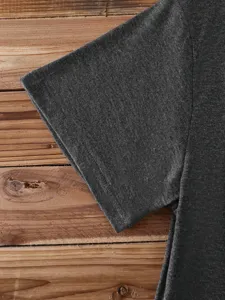 Close up of dark grey short sleeve t-shirt fabric and seam detail, soft cotton knit.