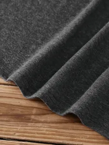 Detailed view of dark grey cotton t-shirt fabric, soft knit texture, casual basic top.