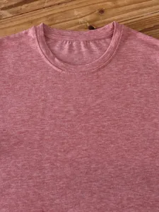 Detailed shot of a casual solid color crew neck short sleeve heather t-shirt in pink.