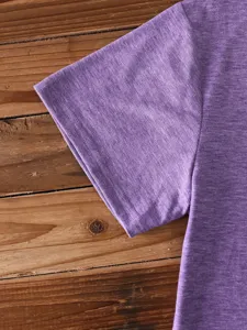 Close-up detail of purple short sleeve t-shirt sleeve, plain cotton casual apparel top.