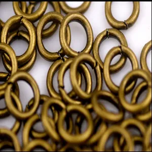 Close-up detail of vintage bronze metal jump rings, perfect for DIY jewelry making and crafts.