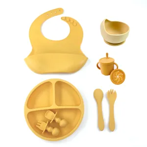 Silicone baby feeding set with suction plate bowl bib cup spoons fork for toddler weaning.