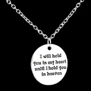 Silver metal round pendant necklace with engraved sentimental quote on black background main view
