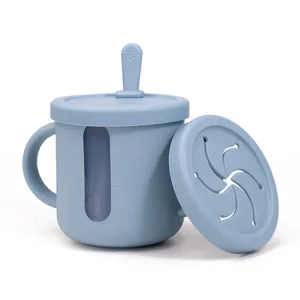 Silicone baby training cup with dual handles, measurement scales, and snack lid for toddlers.