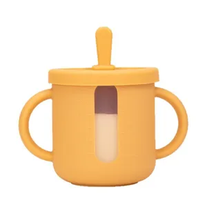 Silicone baby training cup with dual handles and capacity scale window for toddlers.