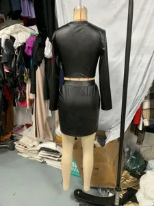 Black faux leather long sleeve crop top and mini skirt two piece set for women.