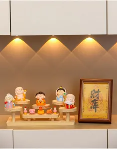 Cute cartoon deity figurines set with wooden tiered display stand for home office desktop decor.