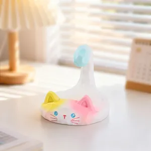Cute cat phone stand detail, creative desktop ornament and lazy phone holder for desk use.