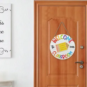 Wooden school classroom welcome sign hanging on wooden door with cute pencil and colorful text.
