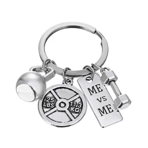 Fitness gym metal keychain detail view showing barbell and kettlebell charms clearly