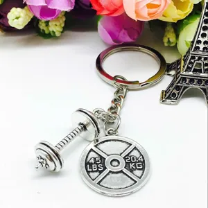 Metal gym fitness keychain with dumbbell and barbell plate charms, creative keyring accessory.