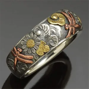 Vintage silver engraved ring with sunflower and dragonfly multi-metal design detail.