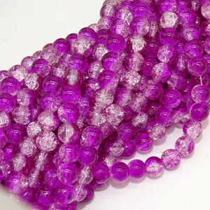 Close-up view of purple crackle glass beads, showing detailed ice crystal texture patterns.