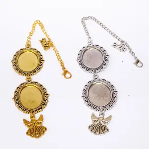 Detail shot of DIY photo bezel tray pendants with angel wings and 2023 charms in gold and silver.