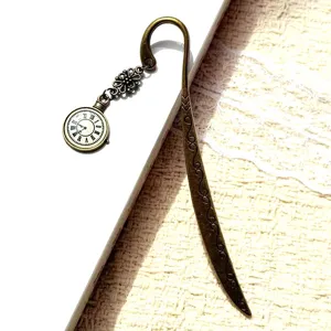 Vintage bronze metal bookmark with clock pendant and carved flower design for reading lovers.