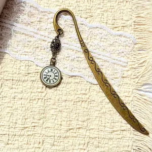 Vintage bronze metal bookmark with clock pendant and carved scroll patterns for book lovers.