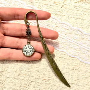 Vintage alloy metal bookmark with clock pocket watch charm and elegant scroll pattern detail.