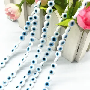 Evil eye glass flat beads detail shot, white and blue Nazar beads for DIY jewelry making.