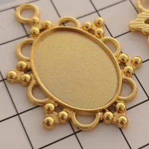 Gold oval alloy bezel tray pendant detail, DIY jewelry making accessory craft base component.