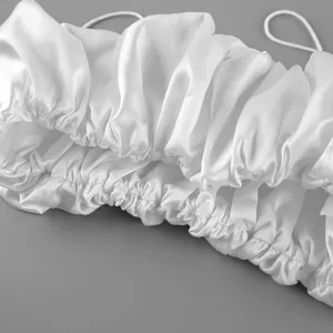 Detail shot of white satin ruched cropped camisole showing delicate gathered texture and fabric.