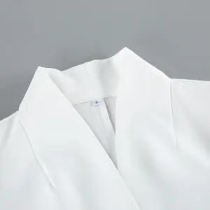 Close-up detail shot showcasing the clean white blazer collar and neckline design with size S tag.