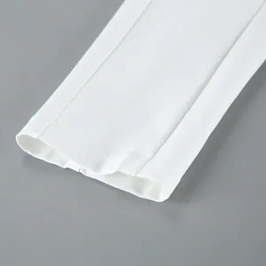 Close-up detail of white women suit jacket sleeve cuff, showing fine stitching and clean fabric texture.