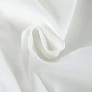 Premium white suit fabric detail showing fine smooth texture and elegant drape style.