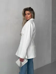 Detail view of the elegant V-neck white blazer with waist-cinching design for women's fashion.