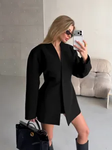 Detail view of the black v-neck blazer featuring a waist-cinching design and front slit.