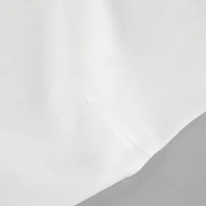 Close-up detail of white sleeveless top fabric and neat stitching, clean styles.