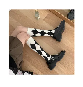 Black and white argyle knee high socks paired with patent leather shoes, classic JK style detail.