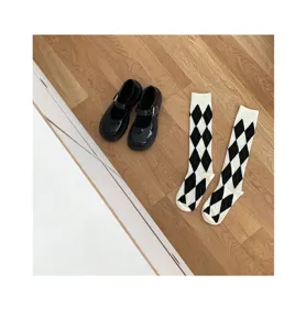 Black patent leather Mary Jane shoes and chic argyle pattern mid-calf socks set, JK style.