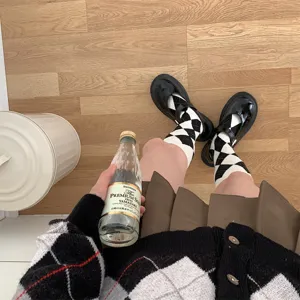 Argyle black and white mid-calf socks detail shot showing classic geometric pattern for JK style.